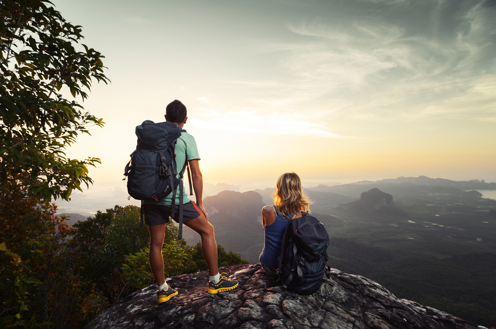 Man and woman hiking after chiropractic adjustments.